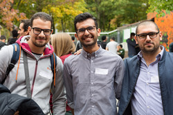 Three men standing next to each other outside of the IBZ