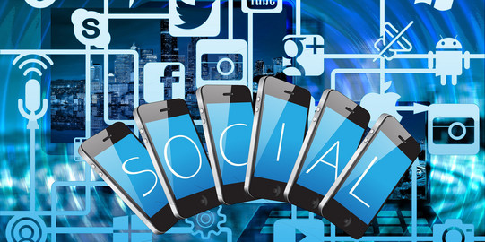 Graphic with social media icons and cell phones fanned out against a skyline background